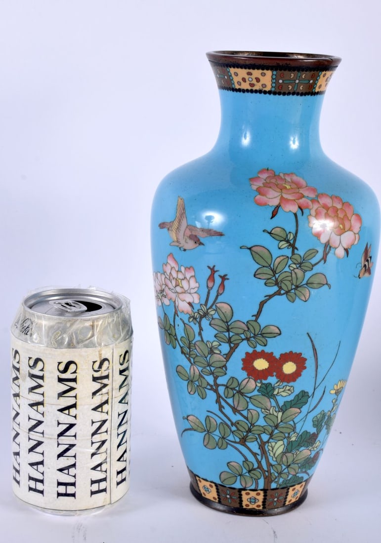 A 19TH CENTURY JAPANESE MEIJI PERIOD CLOISONNE ENAMEL VASE decorated with birds upon a blue ground.: A 19TH CENTURY JAPANESE MEIJI PERIOD CLOISONNE ENAMEL VASE decorated with birds upon a blue ground. 25 cm high.