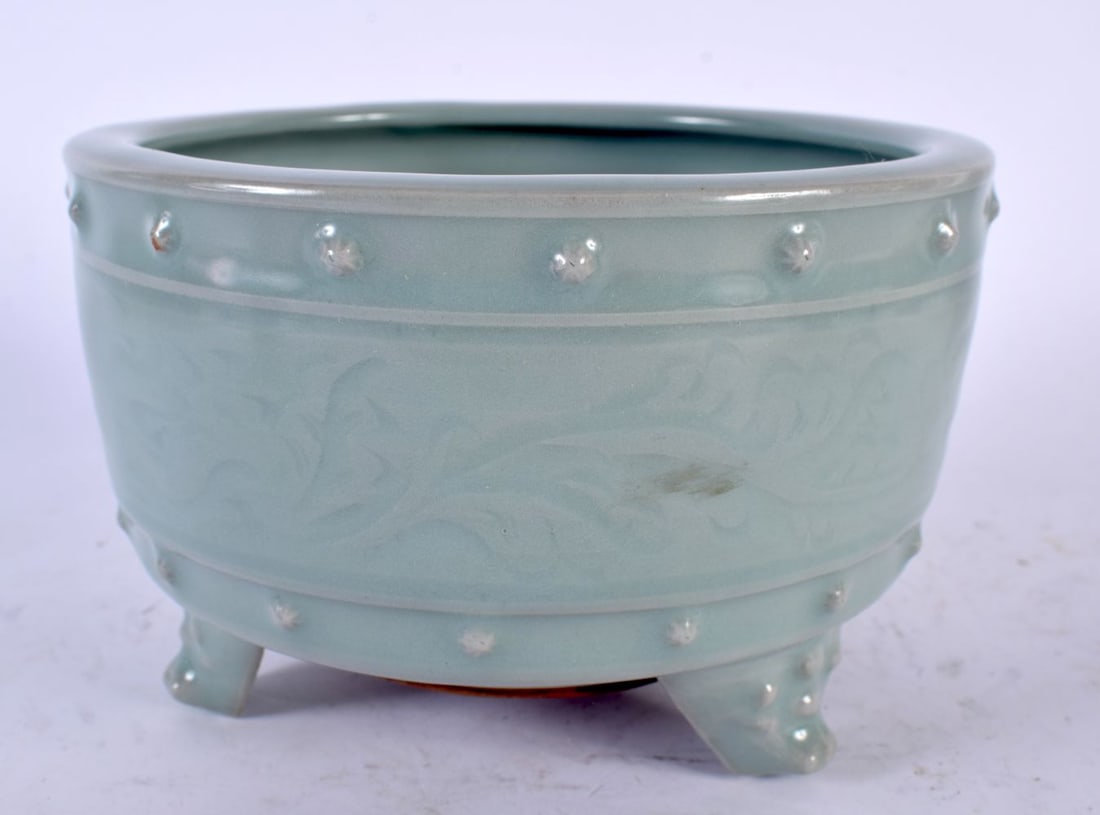 A CHINESE QING DYNASTY LONGQUAN MONOCHROME CELADON STONEWARE CENSER engraved with trailing floral sp: A CHINESE QING DYNASTY LONGQUAN MONOCHROME CELADON STONEWARE CENSER engraved with trailing floral sprays. 15cm wide.