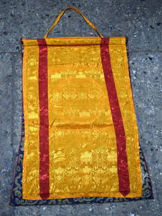A Tibetan printed Mantra Mandala Tanka with a silk embroidered surround 62 x 46 cm.: A Tibetan printed Mantra Mandala Tanka with a silk embroidered surround 62 x 46 cm.