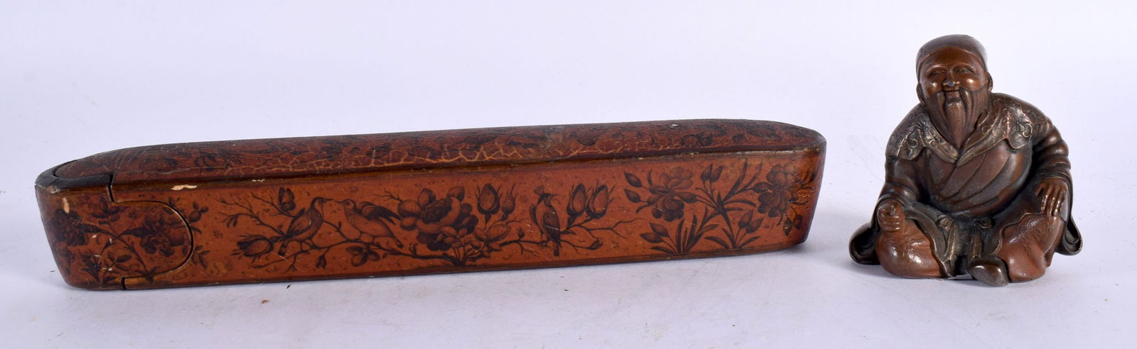 A 19TH CENTURY MIDDLE EASTERN PERSIAN QAJAR LACQUER PEN BOX together with a Japanese okimono. Larges (1 of 7)