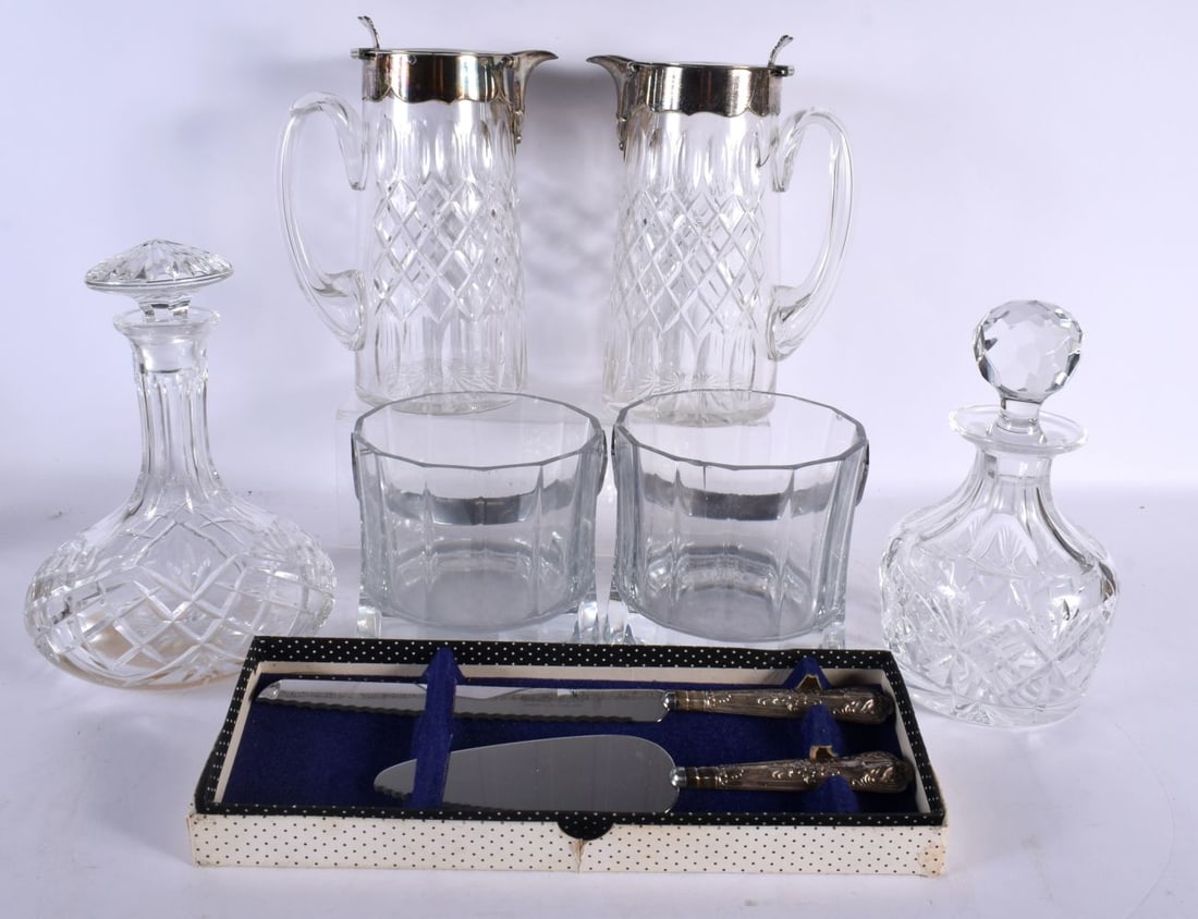 A PAIR OF ANTIQUE SILVER PLATED DECANTERS together with two other decanters, a pair of ice buckets & (1 of 5)