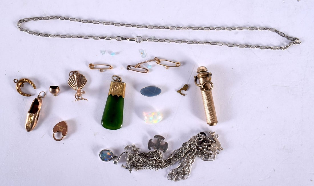 ASORTED GOLD CHARMS together with a yellow metal pencil etc. Gold 4.8 grams, yellow metal 11 grams.: ASORTED GOLD CHARMS together with a yellow metal pencil etc. Gold 4.8 grams, yellow metal 11 grams. (qty)