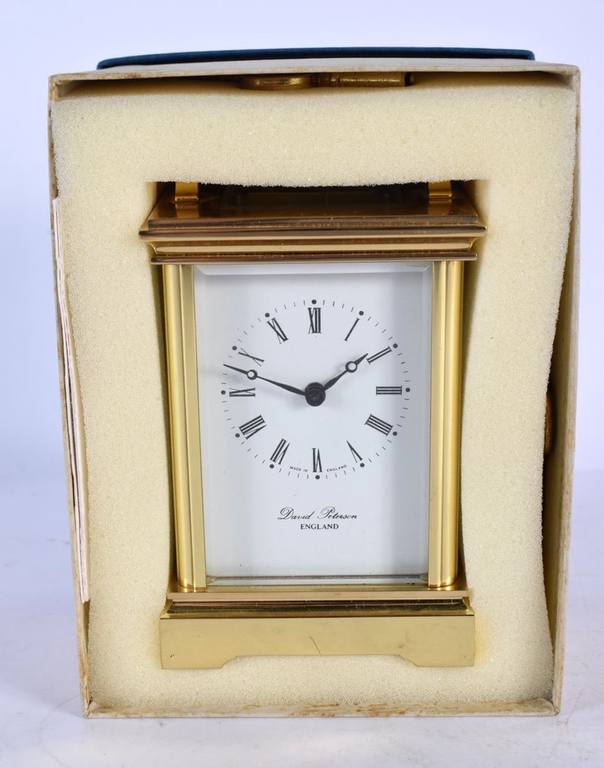 A BOXED DAVID PETERSON BRASS CARRIAGE CLOCK. 15 cm high inc handle.: A BOXED DAVID PETERSON BRASS CARRIAGE CLOCK. 15 cm high inc handle.