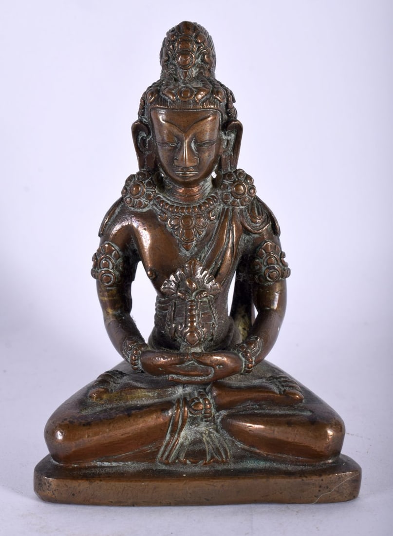 A GOOD 18TH CENTURY TIBETAN NEPALESE BRONZE FIGURE OF A SEATED BUDDHA modelled holding a stupa, upon (1 of 4)