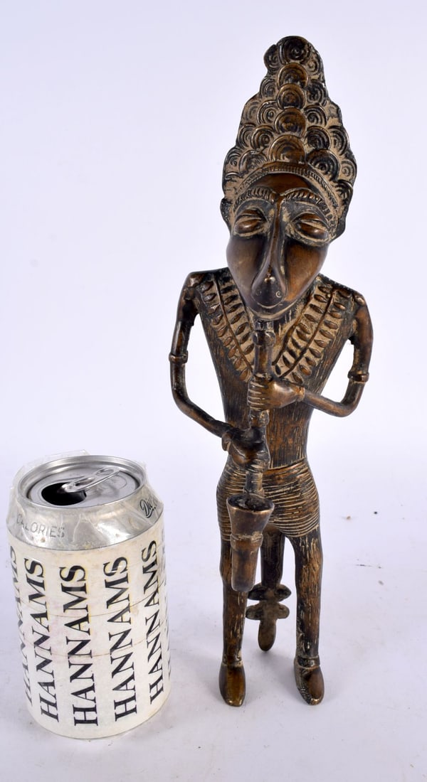A LARGE 19TH CENTURY AFRICAN TRIBAL BRONZE FIGURE OF A WOLF MUSICIAN modelled playing a pipe. 30cm h (1 of 5)