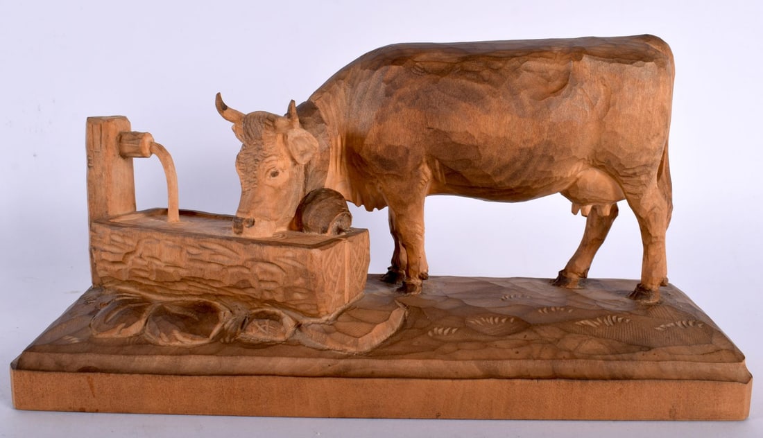 AN UNUSUAL ANTIQUE BAVARIAN BLACK FOREST FIGURE OF A COW modelled drinking water. 26 cm x 15 cm. (1 of 6)