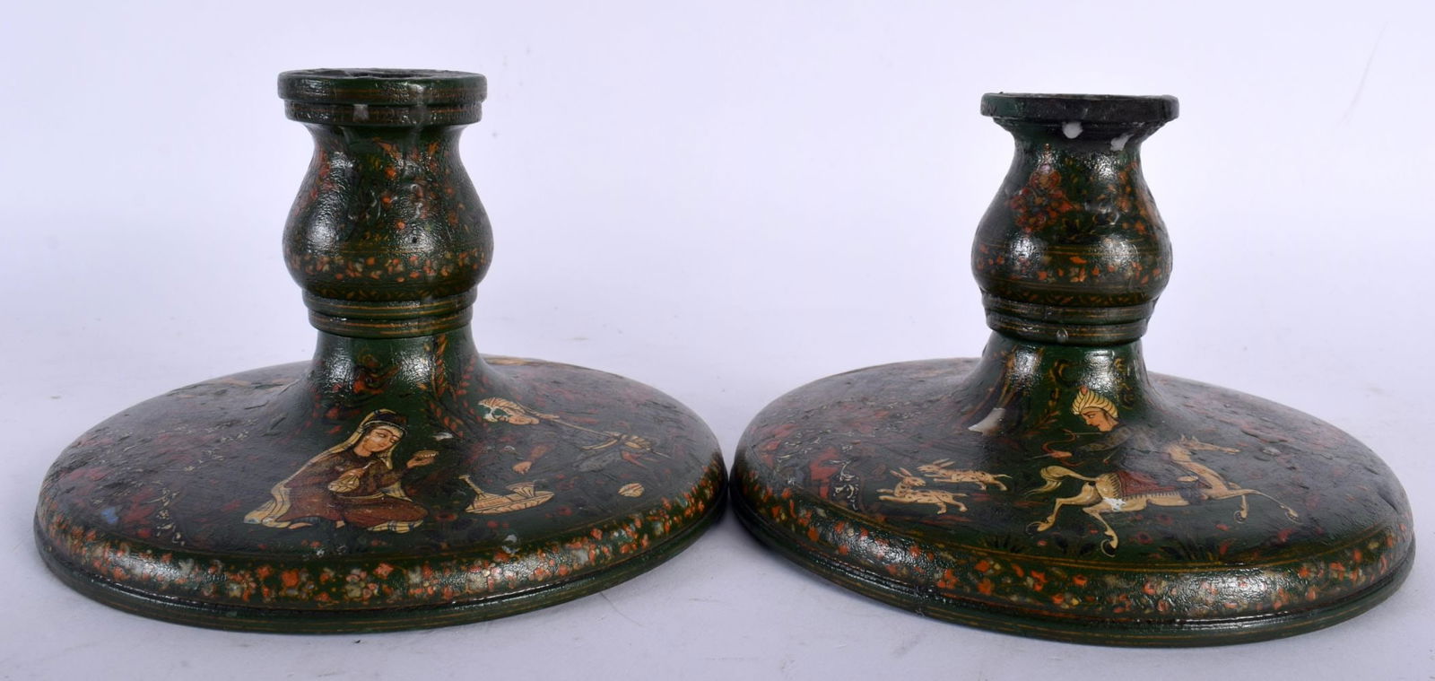 A PAIR OF 19TH CENTURY PERSIAN QAJAR LACQUER WOOD CANDLESTICKS of squat form. 14.5 cm wide. (1 of 3)