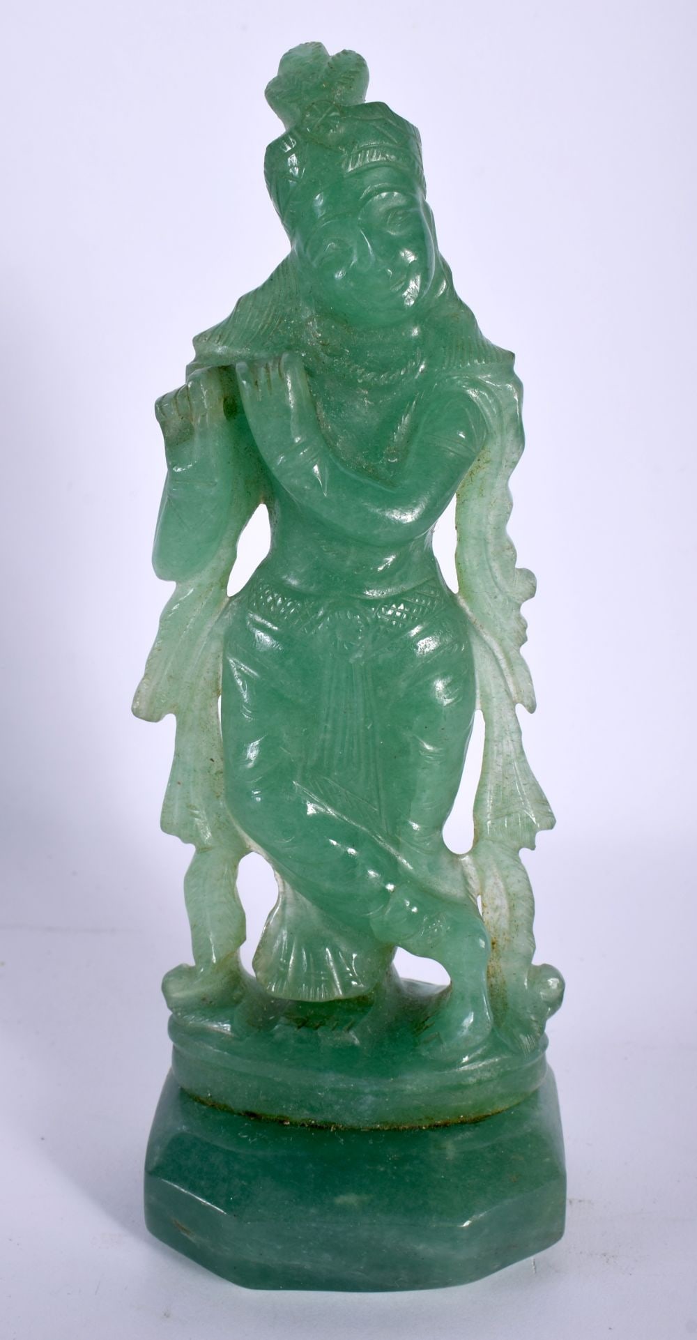 A RARE 19TH CENTURY INDIAN CARVED JADE FIGURE OF A FEMALE DEITY modelled playing a pipe. 17 cm high. (1 of 5)