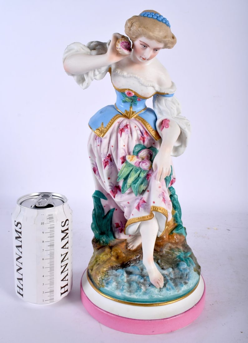 A LARGE 19TH CENTURY FRENCH BISQUE PORCELAIN FIGURE OF A FEMALE modelled holding shells beside a riv: A LARGE 19TH CENTURY FRENCH BISQUE PORCELAIN FIGURE OF A FEMALE modelled holding shells beside a river. 31 cm high.
