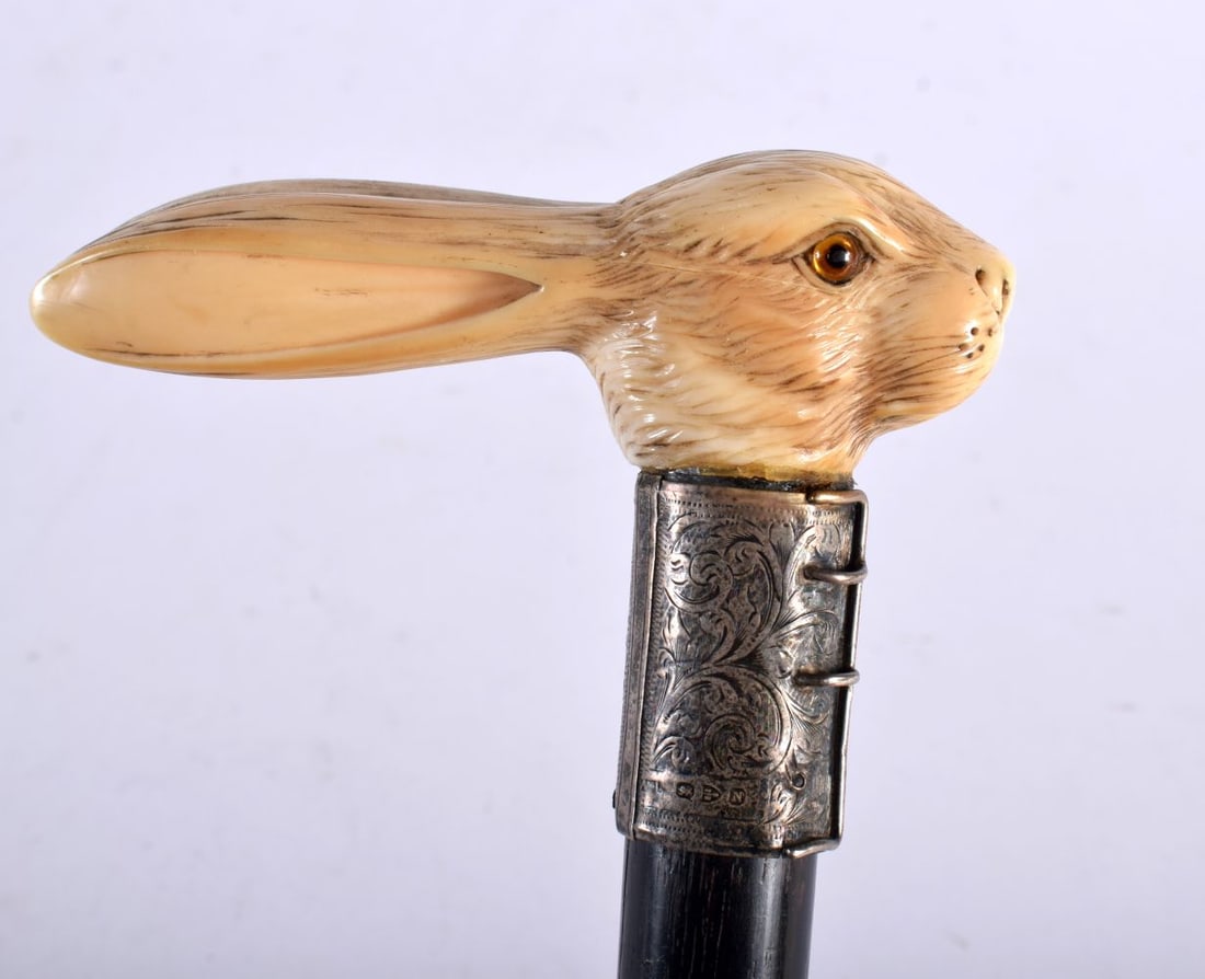 A Carved Bone Rabbit Head Walking Cane with a Niello Silver Collar. 92cm long: A Carved Bone Rabbit Head Walking Cane with a Niello Silver Collar. 92cm long
