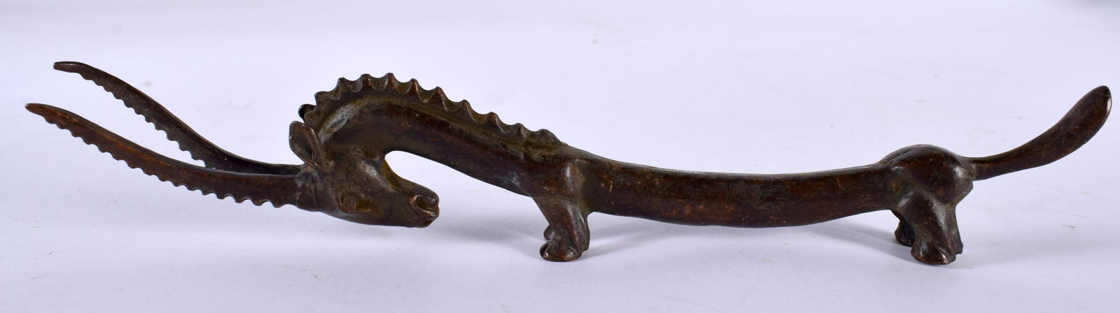 A Japanese Bronze Scroll Weight in the form of an Elongated Elk.19cm x 3.2cm x 1.7cm, weight 119g (1 of 4)