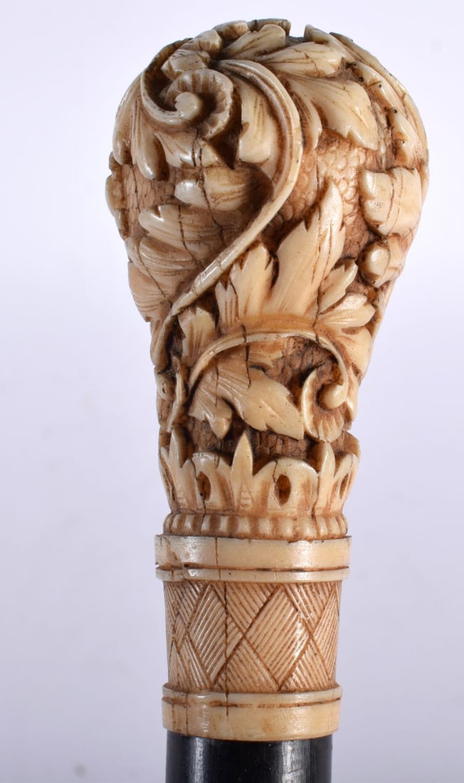 A Carved Bone Handled Walking Cane with a Brass Ferrule. 91cm long: A Carved Bone Handled Walking Cane with a Brass Ferrule. 91cm long