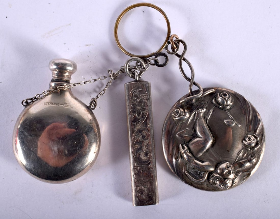 A Silver Scent Bottle on a Finger Chain (stamped Sterling) together with a Mirror and a Pencil Holde: A Silver Scent Bottle on a Finger Chain (stamped Sterling) together with a Mirror and a Pencil Holder. (3)