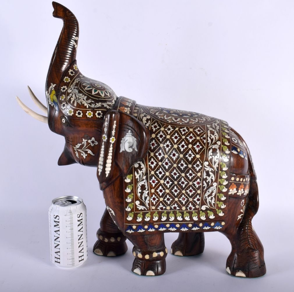 AN UNUSUAL LARGE EARLY 20TH CENTURY ANGLO INDIAN COUNTRY HOUSE ELEPHANT decorative all over with flo: AN UNUSUAL LARGE EARLY 20TH CENTURY ANGLO INDIAN COUNTRY HOUSE ELEPHANT decorative all over with floral motifs and trailing vines, decorative with foliage. 44 cm x 32 cm.