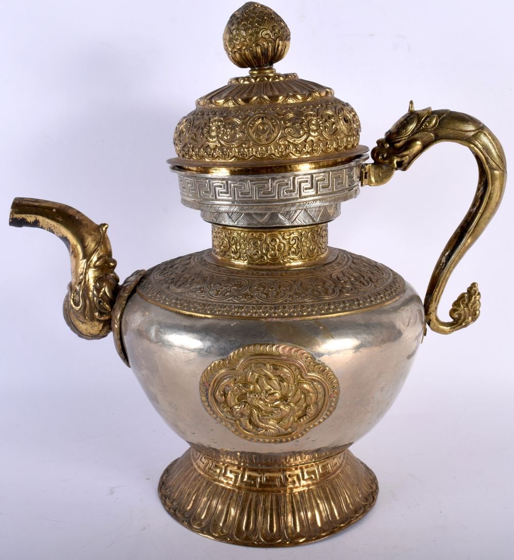 A GOOD 18TH/19TH CENTURY TIBETAN GILT AND SILVER EWER decorative in relief with BUDDHIST motifs. 36: A GOOD 18TH/19TH CENTURY TIBETAN GILT AND SILVER EWER decorative in relief with BUDDHIST motifs. 36 cm x 27 cm.