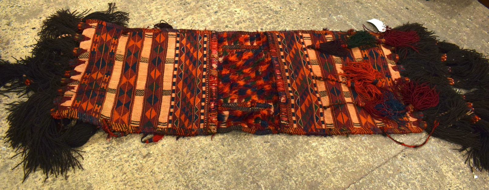 AN EMBROIDERED MIDDLE EASTERN SADDLE BAG. 190 cm x 60 cm. (1 of 4)