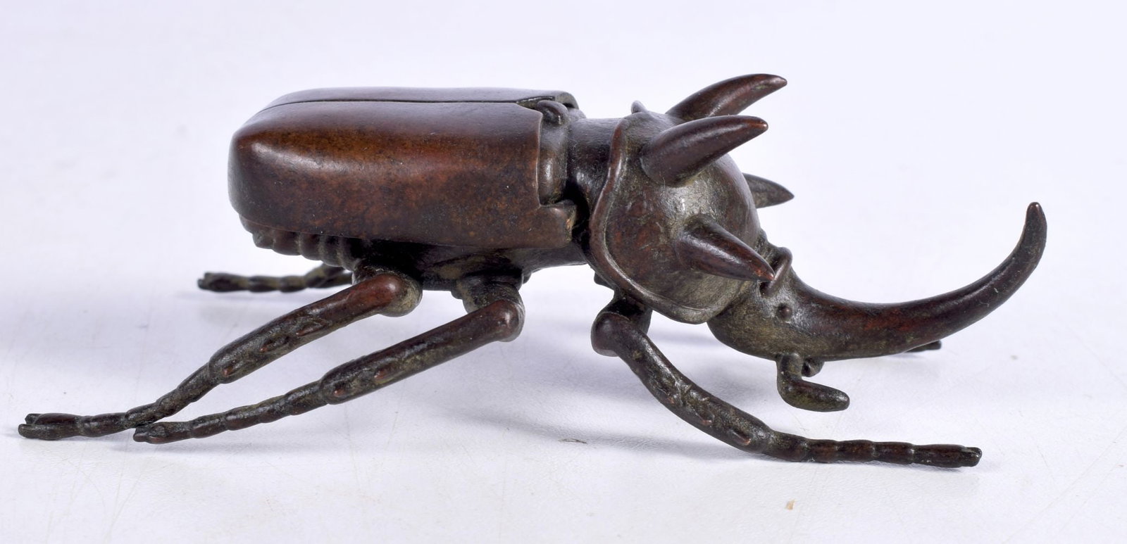 A Japanese bronze Rhinoceros Beetle 3.5 x 11 cm.: A Japanese bronze Rhinoceros Beetle 3.5 x 11 cm.