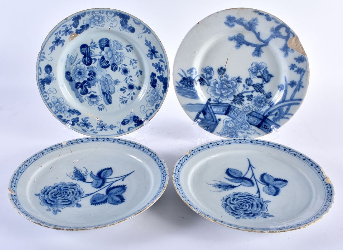 AN UNUSUAL PAIR OF 18TH CENTURY DELFT TIN GLAZED POTTERY BOTANICAL PLATES together with two others. (1 of 7)