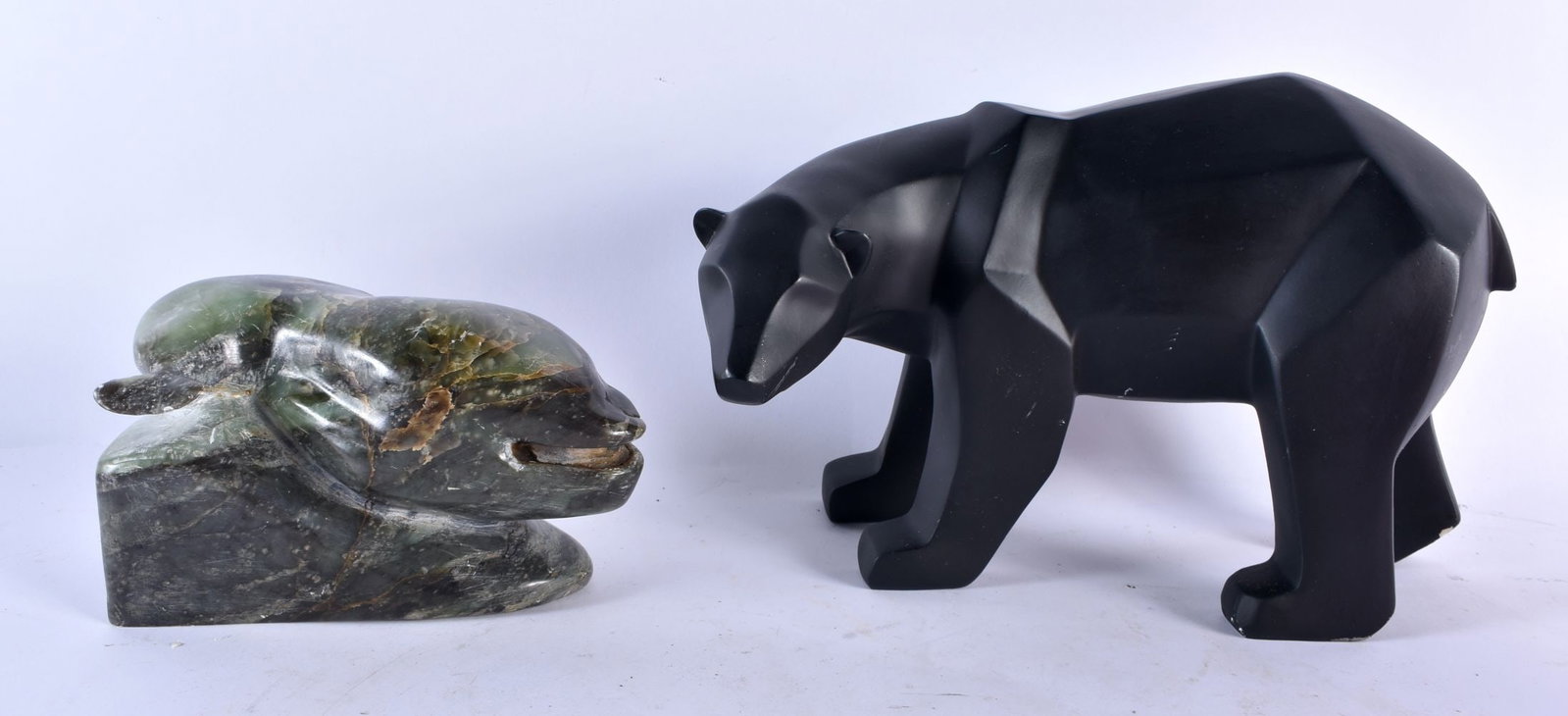 A CONTEMPORARY POLAR BEAR SCULPTURE TOGETHER WITH A POLISHED STONE SKUPTURE OF A WHALE LARGEST. 18 c: A CONTEMPORARY POLAR BEAR SCULPTURE TOGETHER WITH A POLISHED STONE SKUPTURE OF A WHALE LARGEST. 18 cm X 27 cm. (2)