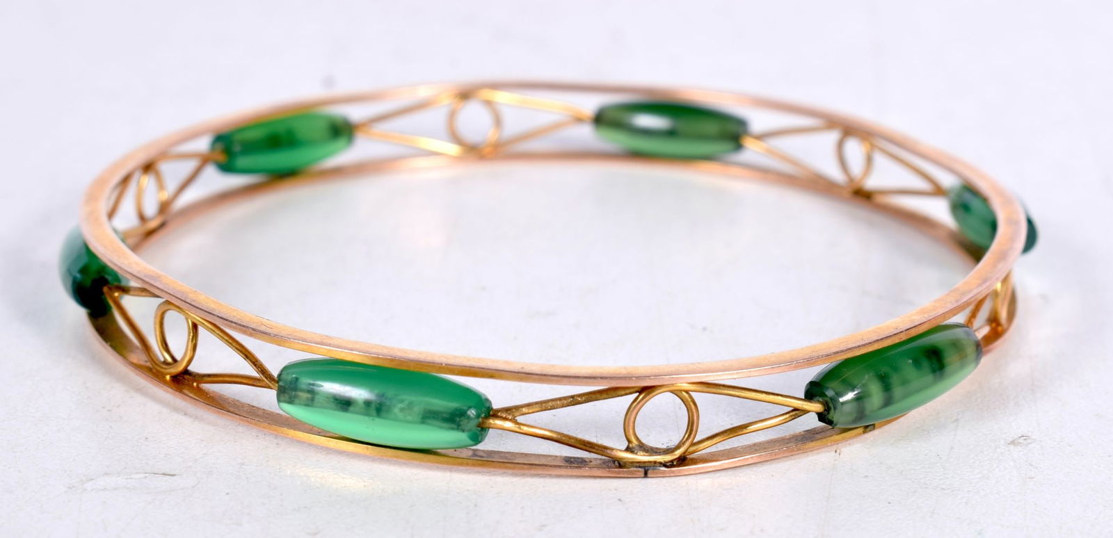 A 9ct Gold Bangle set with Green Gems. Internal Diameter 7.2cm, Stamped 9CT, weight 17g (1 of 3)