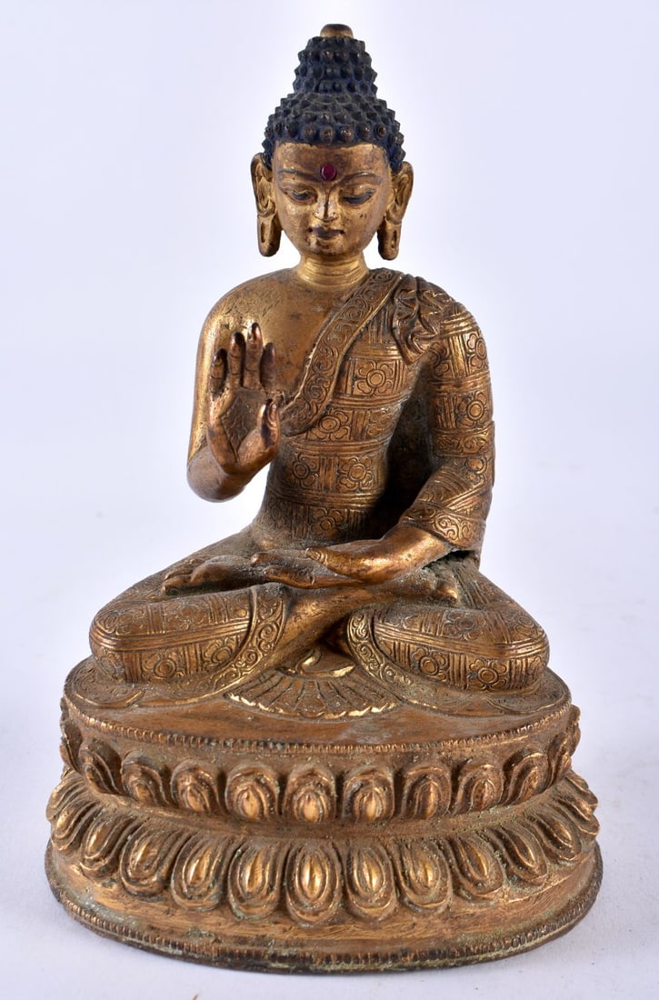 A 19TH CENTURY CHINESE TIBETAN GILT BRONZE FIGURE OF A BUDDHA Qing, inset with a red gemstone. 15 c: A 19TH CENTURY CHINESE TIBETAN GILT BRONZE FIGURE OF A BUDDHA Qing, inset with a red gemstone. 15 cm x 8 cm.