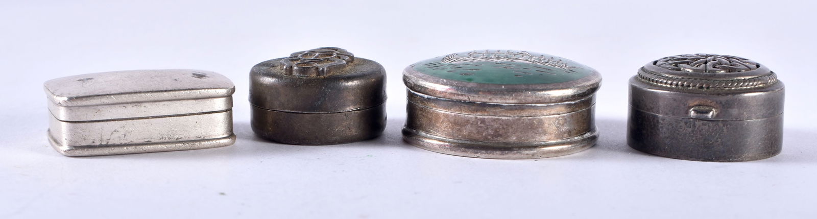 A Silver Pill Box with Enamel Decoration together with 3 other Silver Pill Boxes. Various Stamps.: A Silver Pill Box with Enamel Decoration together with 3 other Silver Pill Boxes. Various Stamps. XRF Tested for purity. Largest 3.3cm x 1.4cm, total weight 54g (4)