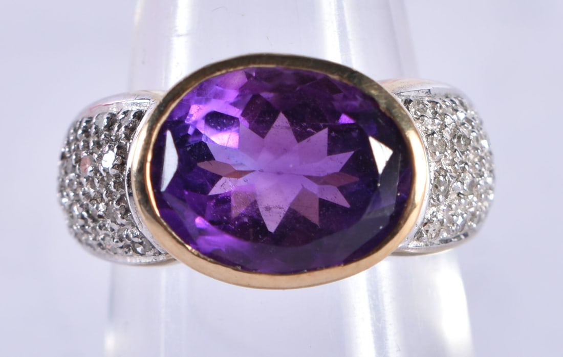 An 9 Ct Gold Ring set with an Amethyst with diamond shoulder.  Size M, weight 5.61g (1 of 4)