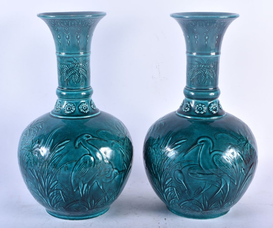 A PAIR OF 19TH CENTURY FRENCH BLUE GLAZED MAJOLICA POTTERY VASES Attributed to Theodore Deck, decora: A PAIR OF 19TH CENTURY FRENCH BLUE GLAZED MAJOLICA POTTERY VASES Attributed to Theodore Deck, decorated with storks in relief amongst reeds. 32 cm x 17 cm.
