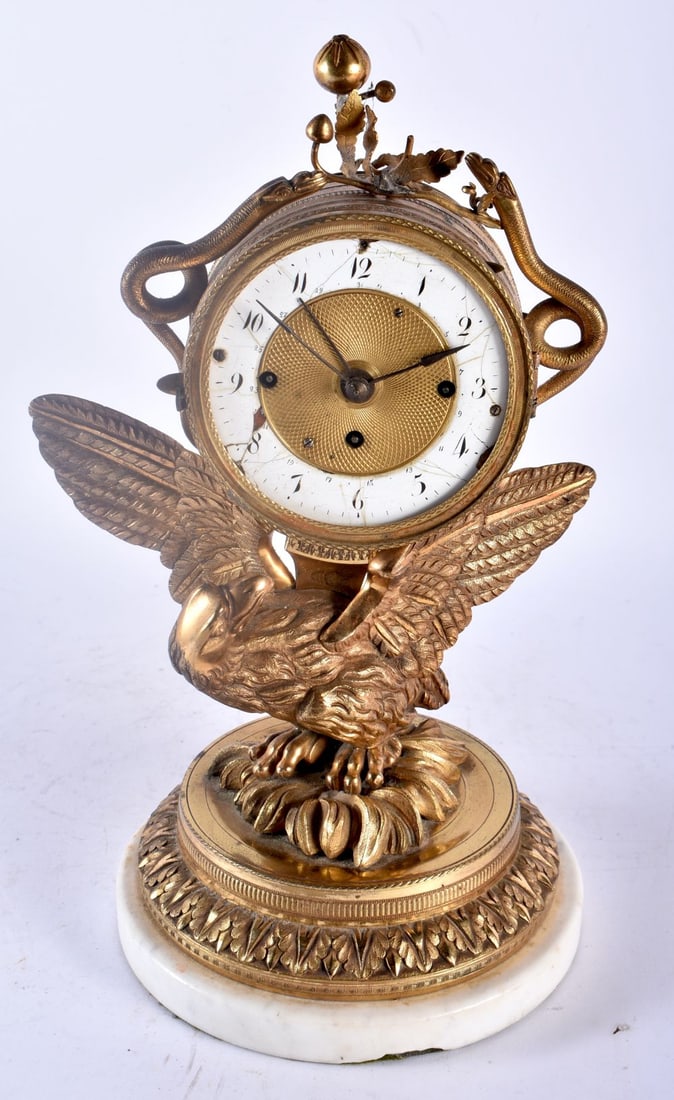 A 19TH CENTURY FRENCH EMPIRE STYLE BRONZE FIGURE OF AN EAGLE CLOCK modelled holding aloft an enamel (1 of 4)