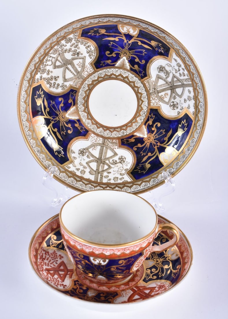 Spode teacup and saucer painted with the ?Dollar? pattern and a saucer dish in the same pattern but: Spode teacup and saucer painted with the ?Dollar? pattern and a saucer dish in the same pattern but in blue and grey. largest 19 cm (3)
