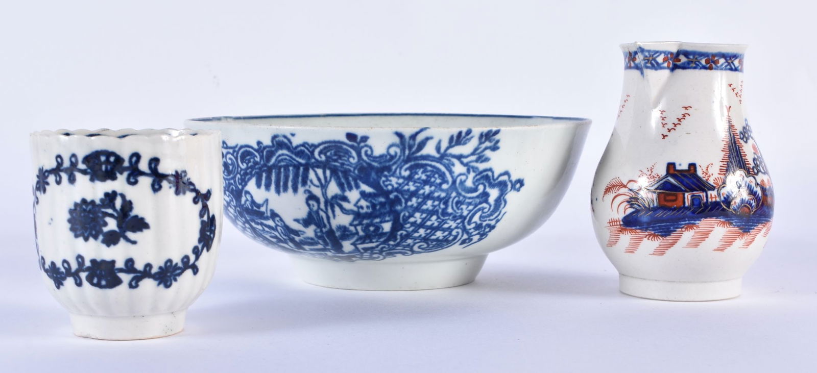 Liverpool, Pennington, sparrow beak jug painted in underglaze blue and overglaze red with the Cannon: Liverpool, Pennington, sparrow beak jug painted in underglaze blue and overglaze red with the Cannonball pattern, a Liverpool bowl with Mother, Child and Man Fishing, and a Liverpool fluted wreath cof