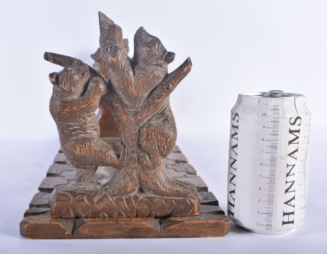 A 19TH CENTURY BAVARIAN BLACK FOREST CARVED LINDEN WOOD EXTENDING BOOK RACK formed with two bears cl (1 of 5)