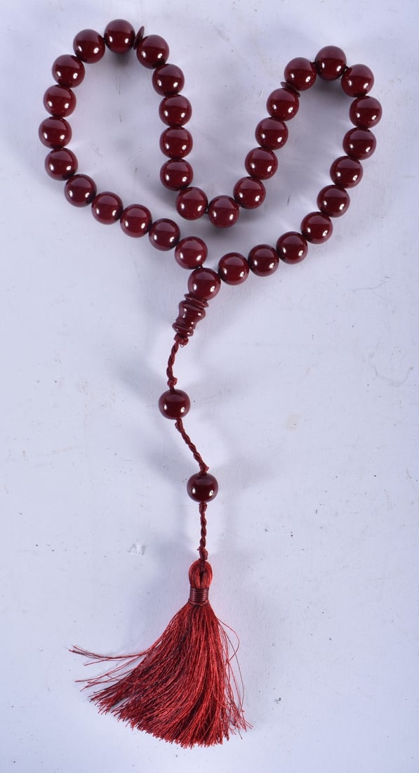 A TURKISH CHERRY AMBER TYPE TESBIH NECKLACE. 93 grams. 94 cm long.: A TURKISH CHERRY AMBER TYPE TESBIH NECKLACE. 93 grams. 94 cm long.