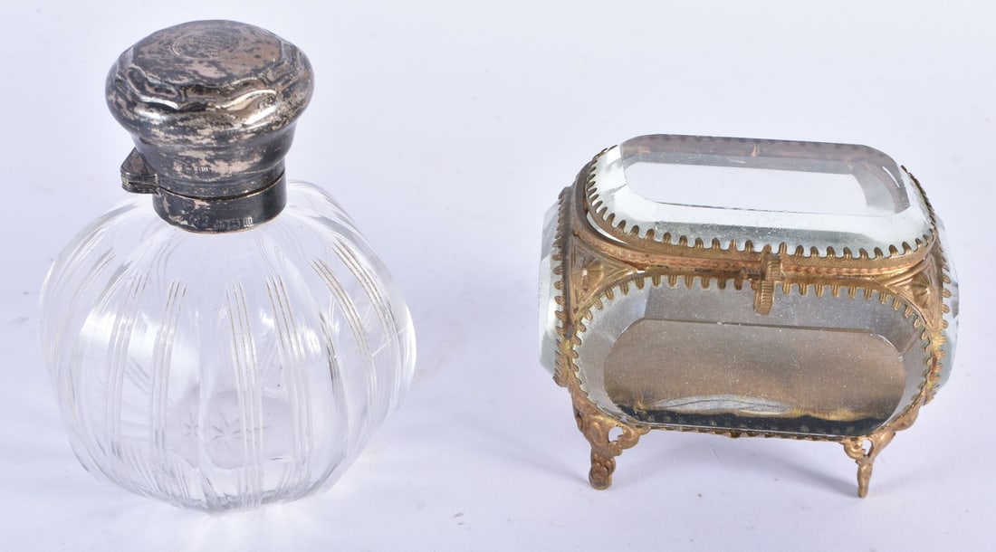AN ANTIQUE SILVER MOUNTED CUT GLASS SCENT BOTTLE together with a small crystal glass jewellery box. (1 of 9)