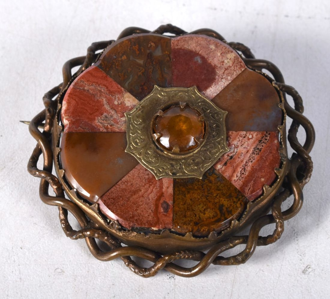 A Victorian Scottish Agate Brooch set with a centre gemstone.  5.6 cm diameter, weight 27.1g (1 of 3)