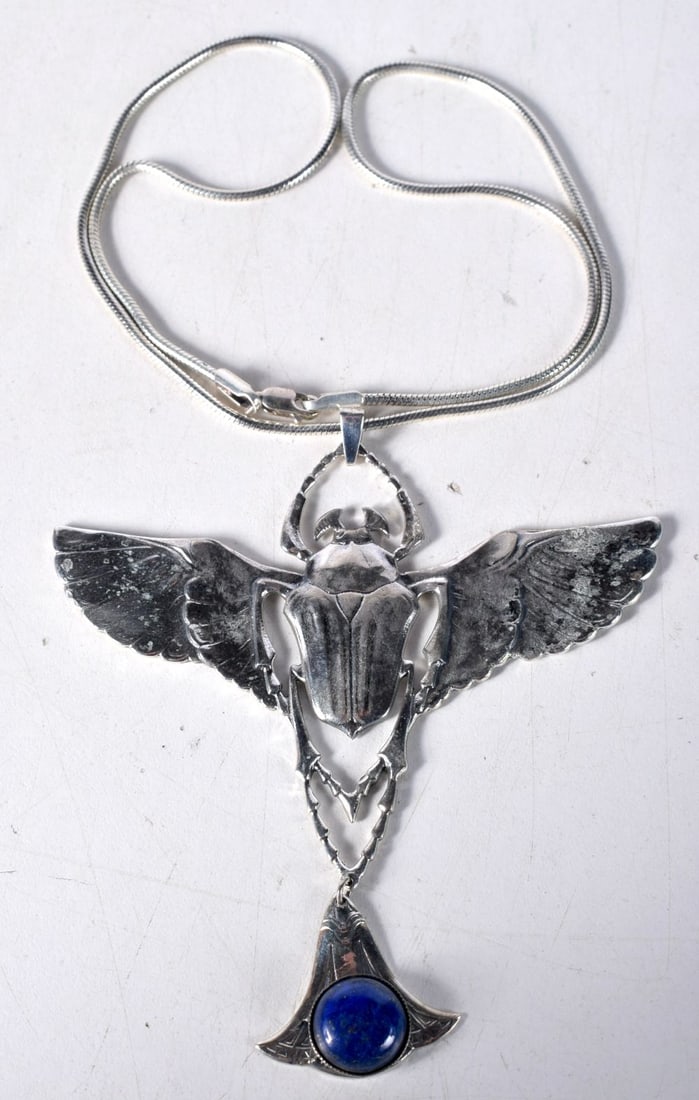 A Silver Necklace with a Scarab Beetle Pendant with Lapis Dropper. Stamped Sterling. Chain 47cm lo: A Silver Necklace with a Scarab Beetle Pendant with Lapis Dropper. Stamped Sterling. Chain 47cm long, Pendant 9.7cm x 8.7cm, weight 42.3g