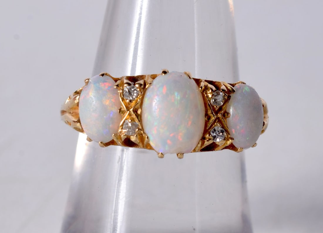 An 18 Carat Gold and Three Stone Opal Ring set with Diamonds... Stamped 18CT, Size N, weight 4.3g (1 of 3)