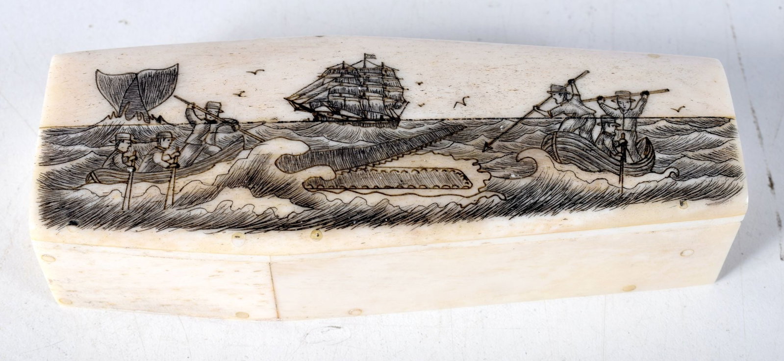 A CONTINENTAL SCRIMSHAW BONE COFFIN. 140.7 grams. 11.5 cm x 4.25cm.: A CONTINENTAL SCRIMSHAW BONE COFFIN. 140.7 grams. 11.5 cm x 4.25cm.