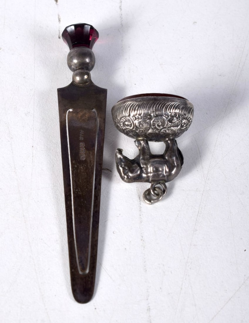 AN ANTIQUE SILVER SEAL and a silver page clip. 11.8 grams. Largest 8.75 cm long. (2): AN ANTIQUE SILVER SEAL and a silver page clip. 11.8 grams. Largest 8.75 cm long. (2)
