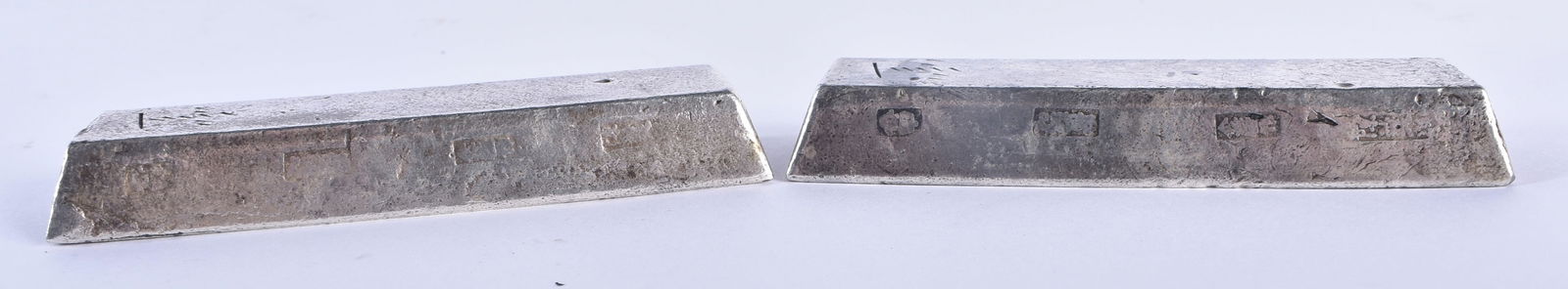 A PAIR OF CHINESE WHITE METAL INGOTS possibly silver scroll weights. 489 grams. 10 cm x 3 cm. (1 of 5)