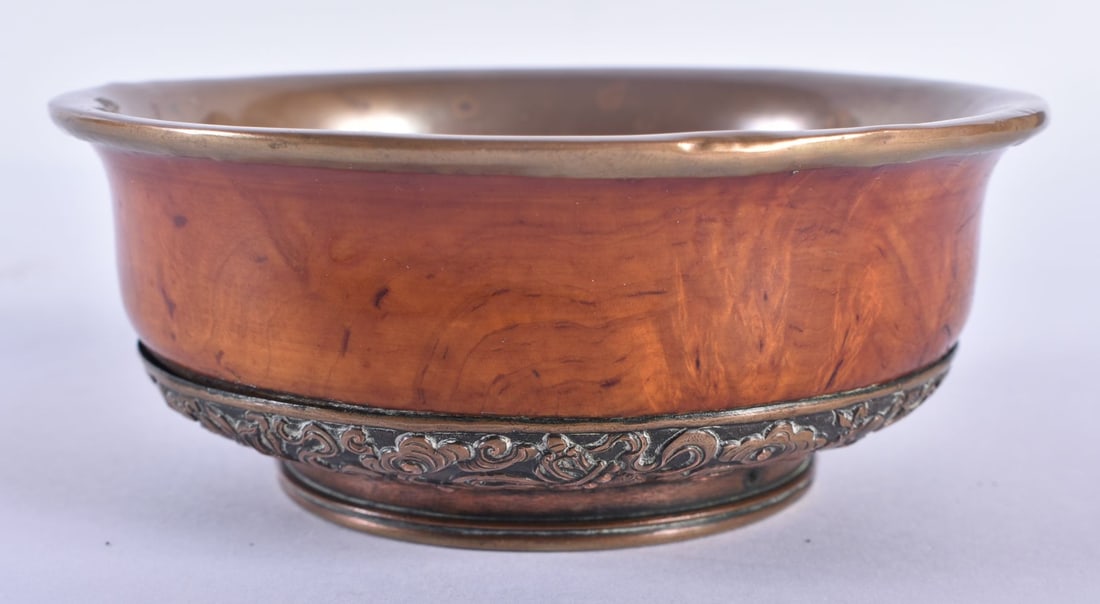 A 19TH CENTURY TIBETAN CARVED WOOD AND COPPER REPOUSSE BOWL decorated with foliage. 12 cm wide.: A 19TH CENTURY TIBETAN CARVED WOOD AND COPPER REPOUSSE BOWL decorated with foliage. 12 cm wide.