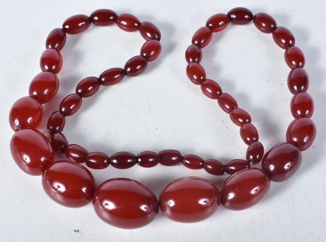 Cherry Bakelite graduated necklace. 66cm long, weight 66g, largest bead 19mm: Cherry Bakelite graduated necklace. 66cm long, weight 66g, largest bead 19mm