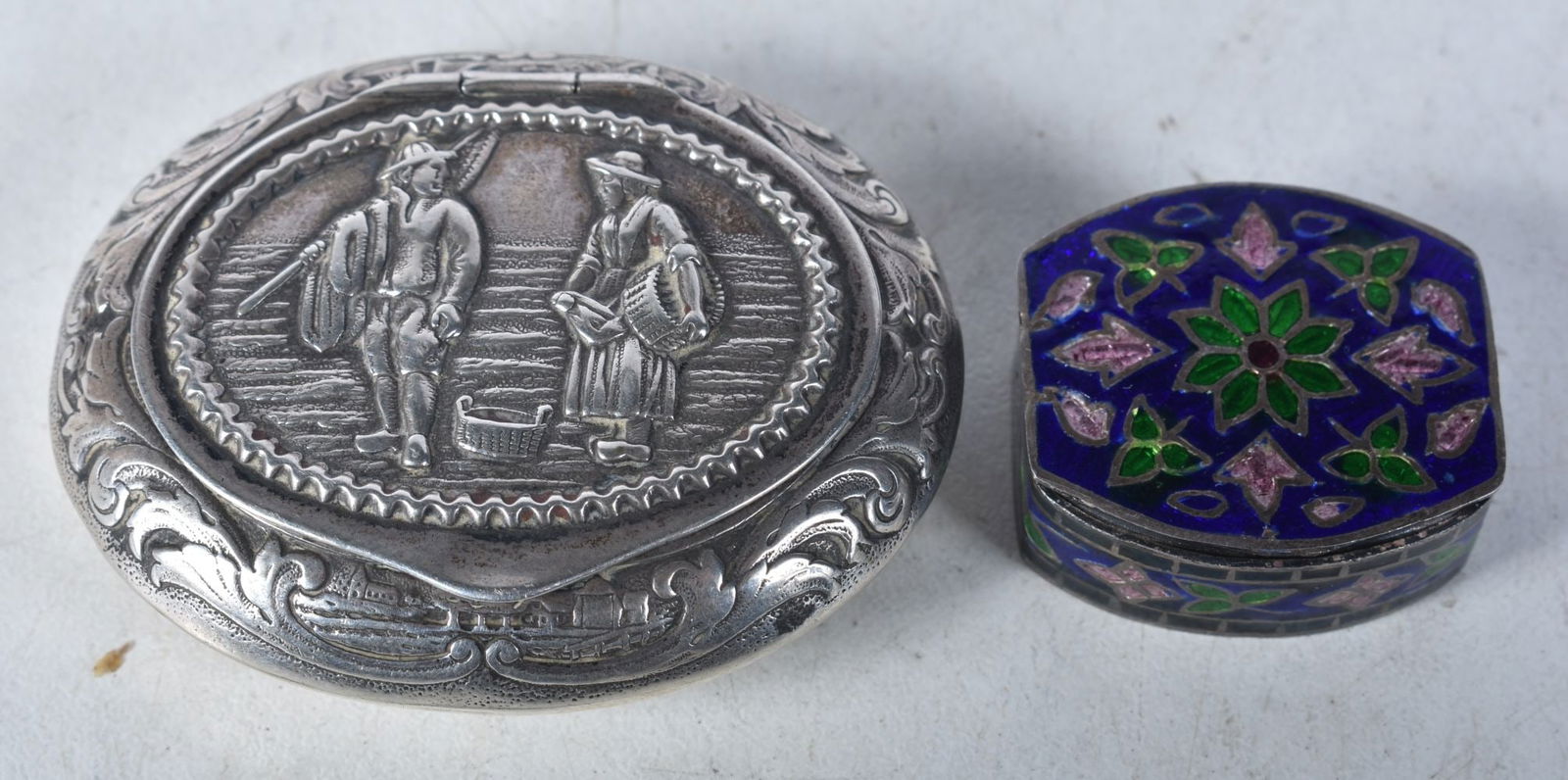 A Dutch Embossed Silver Pill Box and another Silver Enamel Pill Box stamped 925.  Largest 5.1cm x 4. (1 of 3)