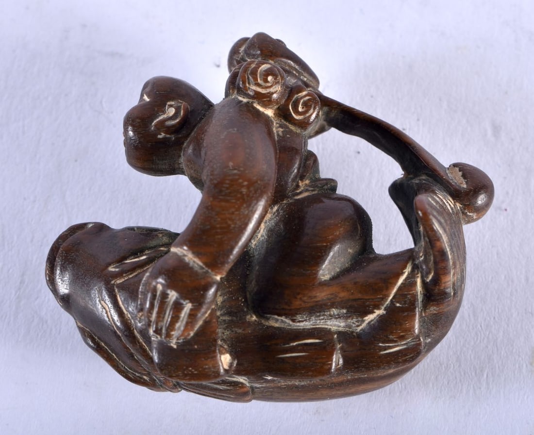 A Carved Hardwood Monkey riding a Gourd. 4 cm x 4.5cm x 2.5cm, weight 14.5g: A Carved Hardwood Monkey riding a Gourd. 4 cm x 4.5cm x 2.5cm, weight 14.5g