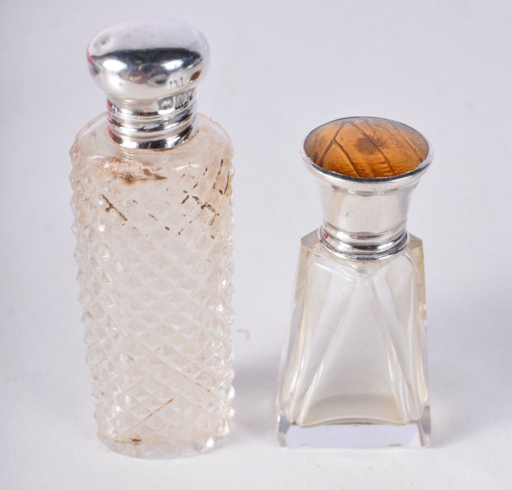 TWO ANTIQUE SILVER TOPPED SCENT BOTTLES. 52 grams. Largest 7.25cm x 2.25cm. (2) (1 of 3)