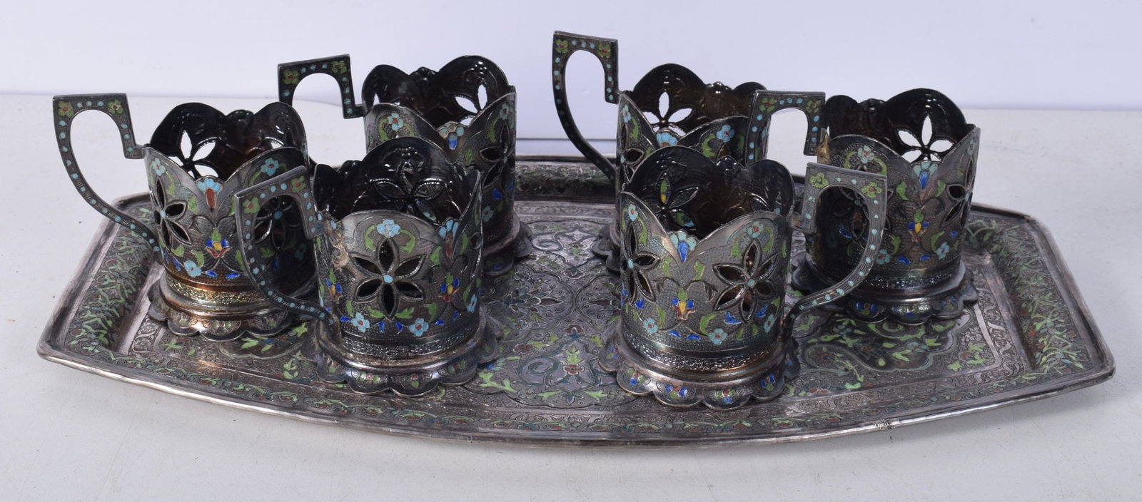A RARE AND UNUSUAL PERSIAN SILVER AND ENAMEL SET OF CUPS ON TRAY decorated all over with foliage and (1 of 5)