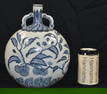 A Chinese porcelain blue and white flask decorated with foliage 26 cm