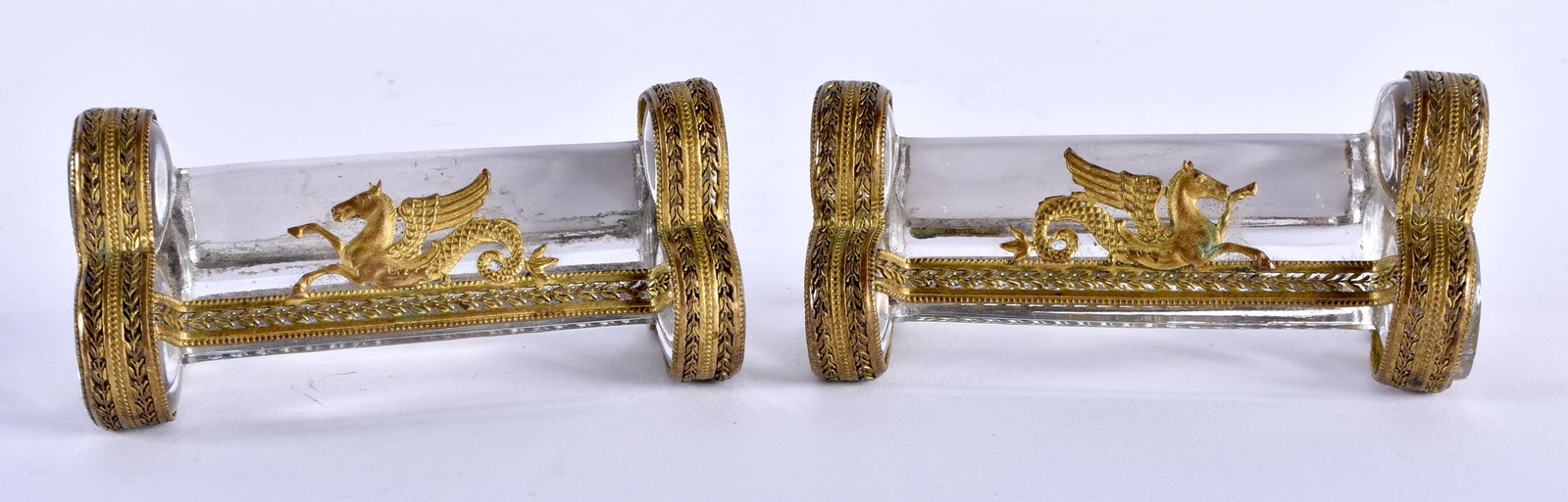 A RARE PAIR OF LATE 19TH CENTURY FRENCH GILT METAL AND GLASS KNIFE RESTS Empire style. 8.75 cm wide.: A RARE PAIR OF LATE 19TH CENTURY FRENCH GILT METAL AND GLASS KNIFE RESTS Empire style. 8.75 cm wide.
