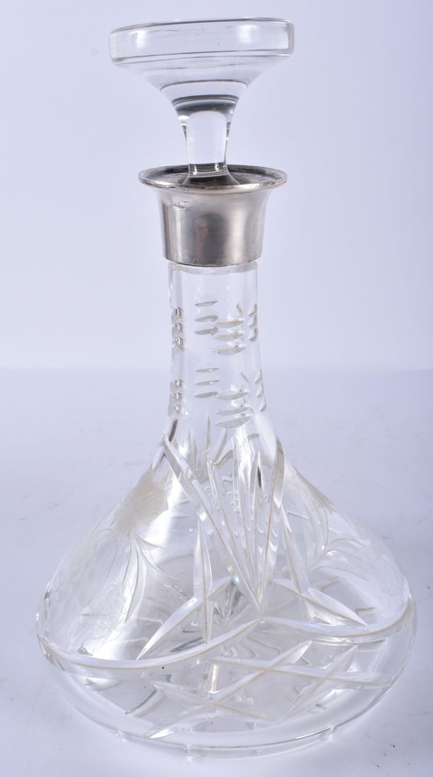 A 1970S SILVER MOUNTED CUT GLASS DECANTER AND STOPPER. London 1976. 26.5 cm high. (1 of 4)