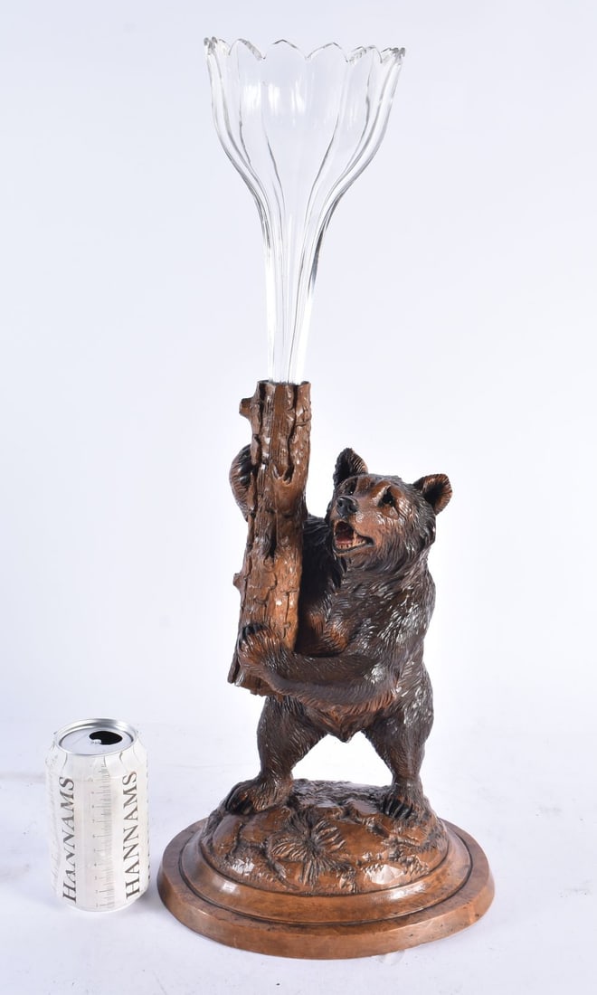 A 19TH CENTURY BAVARIAN BLACK FOREST CARVED WOOD FIGURE OF A BEAR modelled holding aloft a large gla (1 of 3)